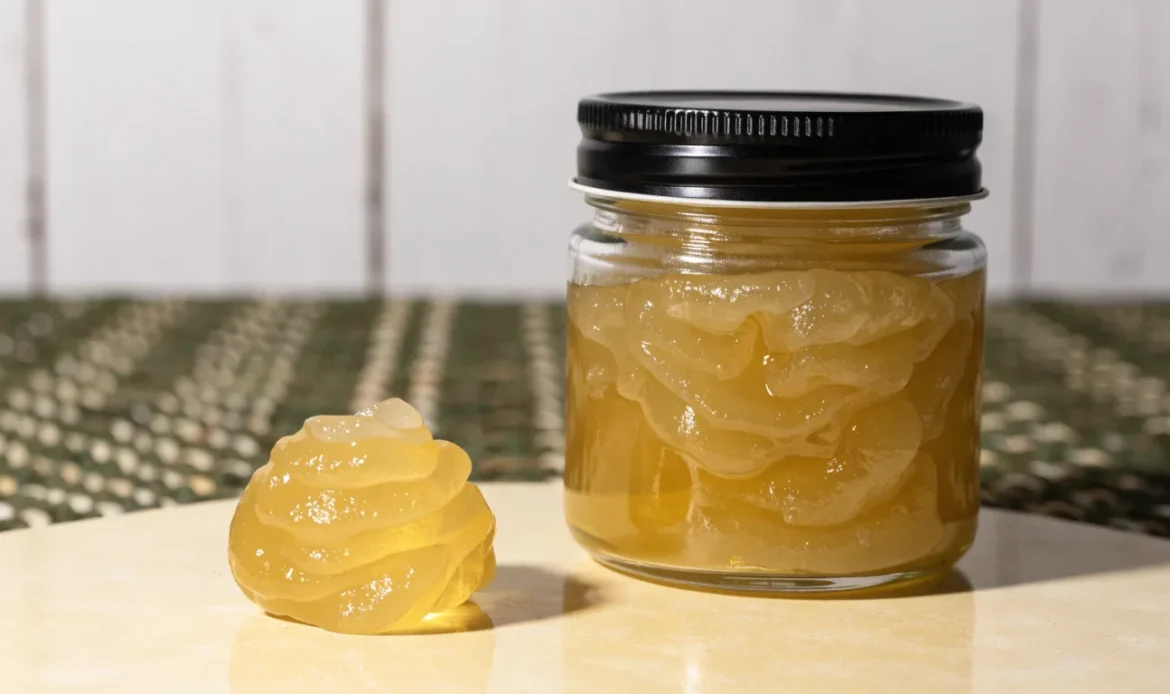 A small measured spoonful of golden sea moss gel beside a closed glass jar on a pale cream surface, restrained clinical styling, illustrating sea moss warnings.